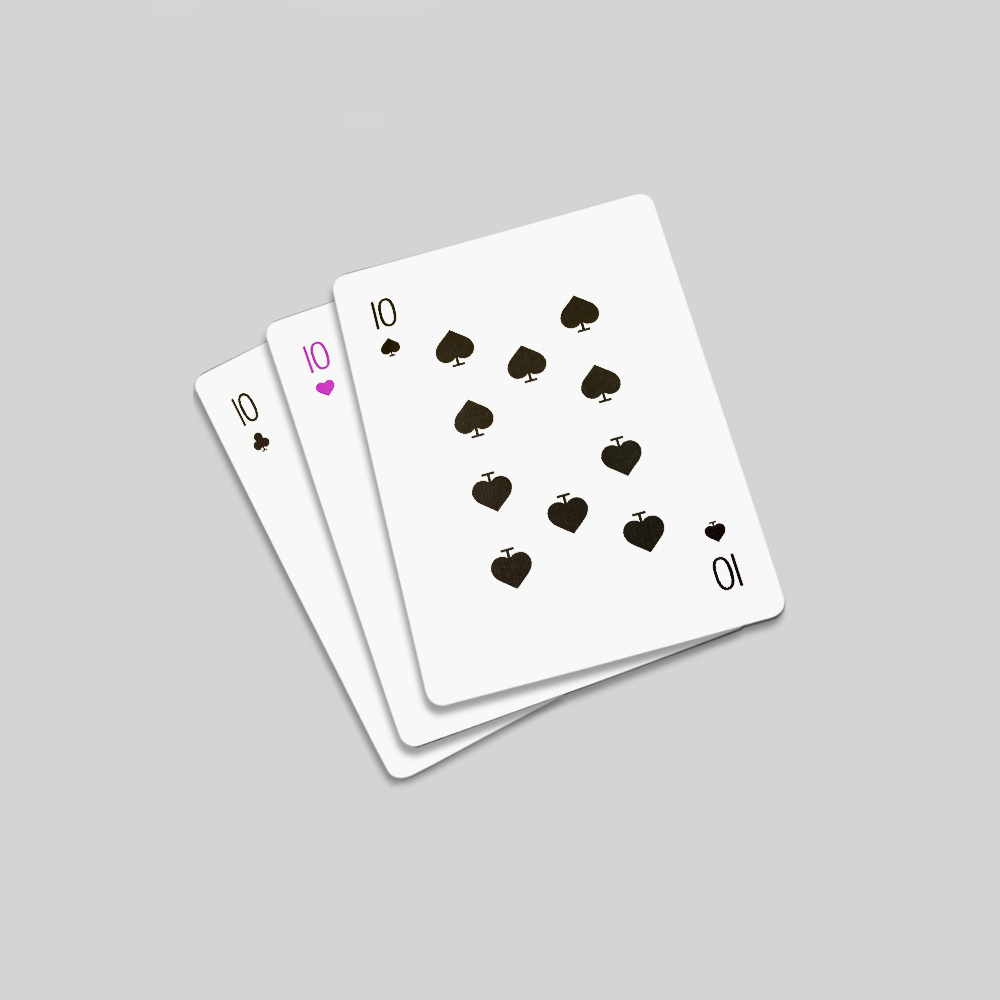 A ten of clubs, ten of hearts, and ten of spades lie in a row.