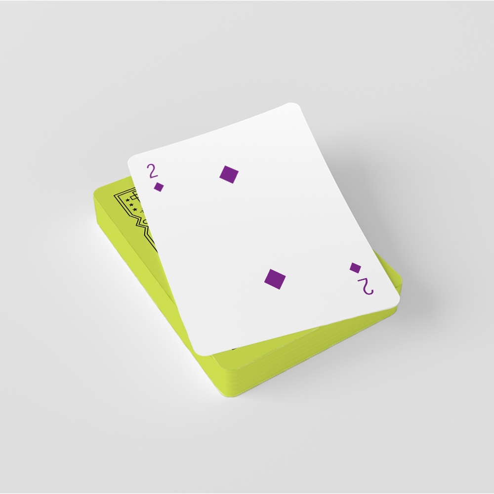 A two of diamonds lays on top of deck of green cards.